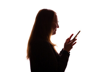 Silhouette of young woman using smartphone on white background