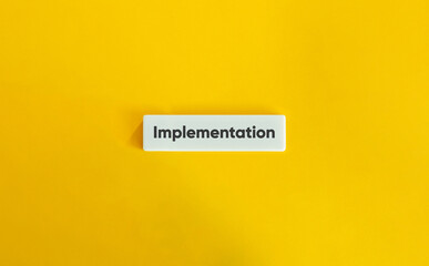 Implementation Word on Letter Tile on Yellow Background – Minimalist Strategy Execution and Planning
