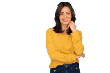 Cheerful latina professional portrait showcasing young woman with long brown hair, yellow shirt, jeans, gently touching her face, isolated white background