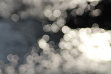 Beautiful shiny silver river background. Beautiful silver water bokeh background. Christmas lights...