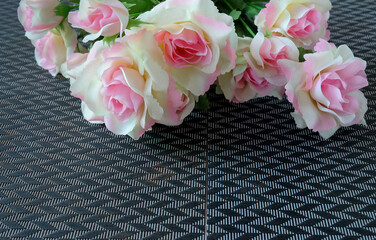 Pink rose flowers in a floral arrangement on background.
