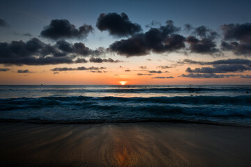 Obraz premium Beautiful sunrise over the sea at Bali Island. Beautiful view and colour of the sky. Magical holiday trip.