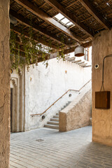 courtyard in an old heritage house with staircase and bamboo roof