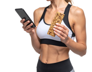 Athletic woman in sportswear holding a smartphone and a granola bar.