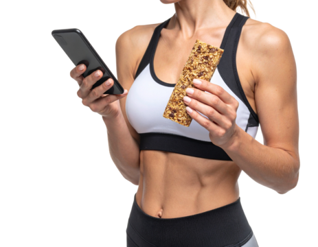 Athletic woman in sportswear holding a smartphone and a granola bar.