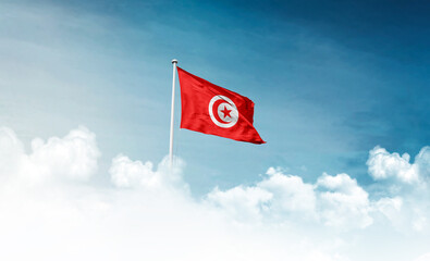 Tunisia national flag with mast waving in beautiful sky. Tunisia flag for Republic Day and...