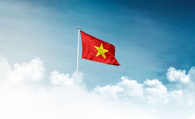 Vietnam national flag with mast waving in beautiful sky. Vietnam flag for Republic Day and Independence Day.