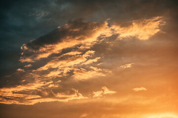 Fototapeta premium Beautiful cloudscape with vibrant orange and yellow colors during sunset, creating a dramatic and breathtaking view