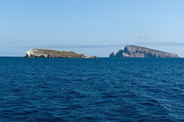 View from a boat to Bottaro island and Lisca Bianca island near Panarea island in the Tyrrhenian Sea. Aeolian (Lipari) islands. Italy. Europe.