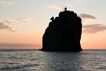 View of Strombolicchio island and Tyrrhenian Sea at sunset near Stromboli island. Aeolian (Lipari) islands. Italy. Europe.
