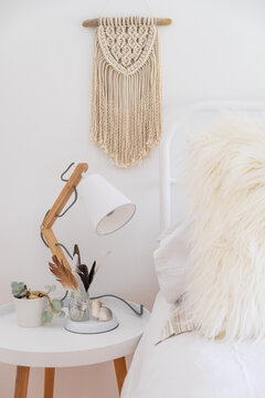 Bohemian style bed with side table and macrame