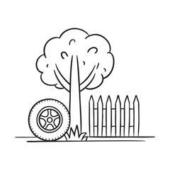 Fototapeta premium A tire resting beside a fence under a tree