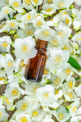 Jasmine essential oil and flowers. Selective focus.