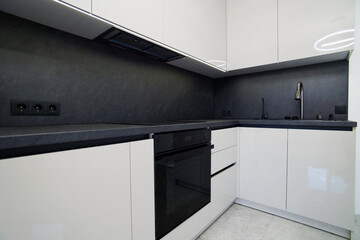 Modern kitchen with minimalist design and sleek black countertops showcasing efficient layout