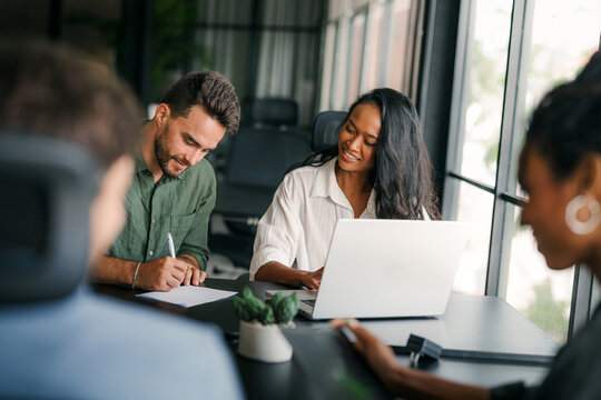 Busy smiling executive business team using digital devices in office. Diverse professional people