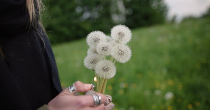 Young Woman Burning Dandelions in Hand &ndash; 4K Mid Shot Conceptual Lifestyle with Dramatic Flames