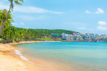 Tropical beach with golden sand, turquoise sea, palm trees and colorful seaside resort buildings with nobody, Phu Quoc island, Vietnam. Hon Thom beach. Summer vacation destination in Asia