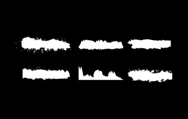 Collection of white paint brush strokes on a black backdrop