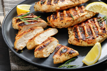 grilled chicken breast with lemon on a plate