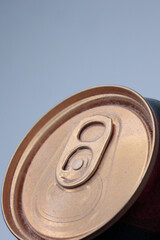 Angled Macro Of A Dusty Golden Aluminum Drink Can Lid With Pull Tab. Smooth Light Blue Gradient...