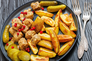 meatballs, potatoes, pickles, berries on a plate