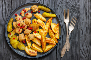 meatballs, potatoes, pickles, berries on a plate
