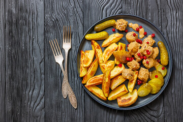 meatballs, potatoes, pickles, berries on a plate