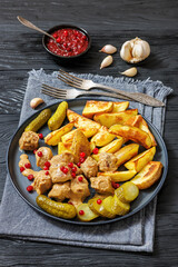 meatballs, potatoes, pickles, berries on a plate