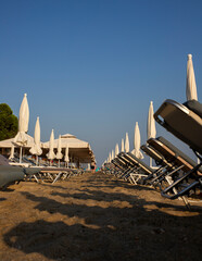 Beach with sun beds and umbrellas near the sea