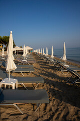 Beach with sun beds and umbrellas near the sea