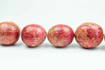 A pile of passion fruits on a white background