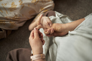 Close-up image of caregiver doing massage to boy with disability during therapy in class