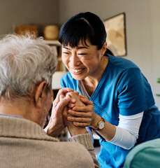 Portrait of a doctor or nurse caregiver supporting senior man, holding hands, high five gesture, at...