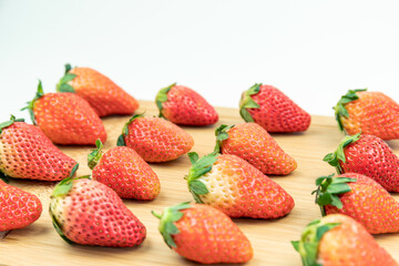 Fresh strawberries neatly arranged on the cutting board