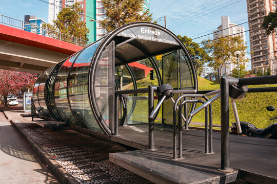 Iconic tube bus station of Curitiba city, Brazil, with its modern glass and metal design, reflects the unique public transportation system of the city.