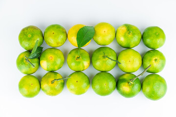 Fresh fruits and oranges neatly arranged on a white background