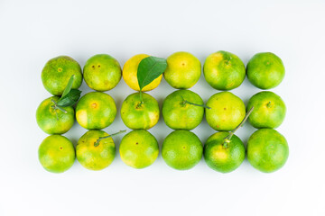 Fresh fruits and oranges neatly arranged on a white background