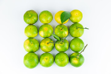 Fresh fruits and oranges neatly arranged on a white background