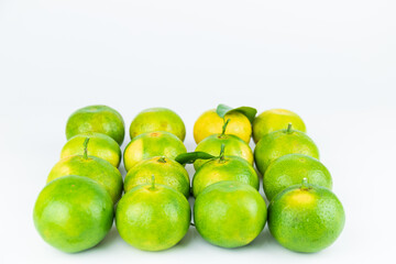 Fresh fruits and oranges neatly arranged on a white background