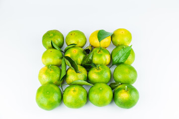 Fresh fruits and oranges neatly arranged on a white background