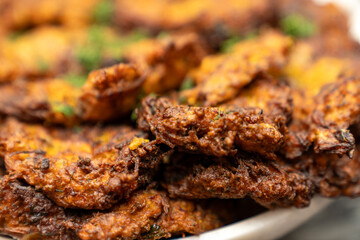 Crispy Golden Vegetable Fritters Close Up. Authentic Homemade Indian Pakora, Deep Fried Street Food Snack, Perfect for Restaurant Menus, Food Blogs, and Culinary Promotions