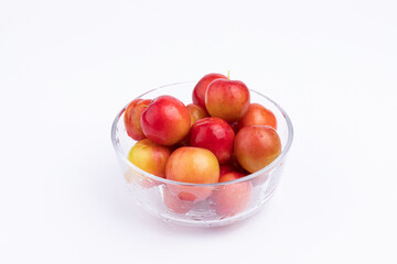 The fresh red plums in the glass bowl