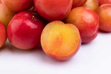 Fresh red plums cut in half