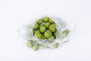 Fresh plums in transparent plastic bags