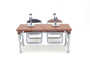 Two Microphones on Desks with Chairs in a Studio