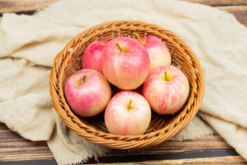 Fresh apples in the fruit plate on the wood-grain table