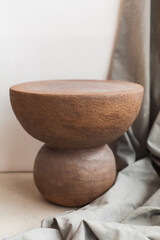 Minimalist still life of handmade ceramic decor in earthy tones. Unique pottery pieces for interior styling: vases, lamps, mirror frames, and home accessories with natural textures