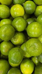 Close-up of fresh green limes with vibrant texture and color, captured on smartphone during summer vacation in Spain. Perfect for healthy living and freshness themes.