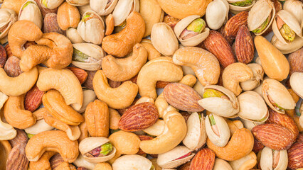 Close-up of roasted nuts, including cashews, almonds, and pistachios.