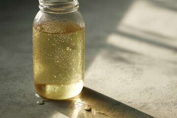 glass water bottle glistening in sunlight covered in condensation